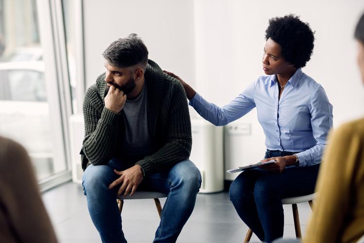 Social worker listening to client and expressing empathy 