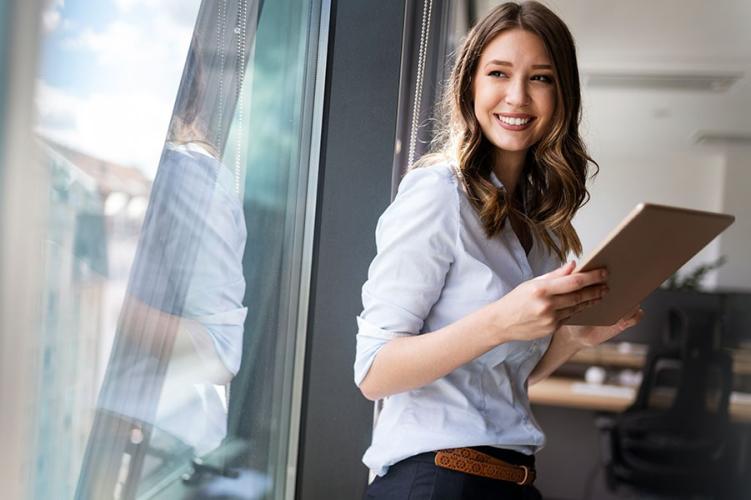 Businesswoman standing by window