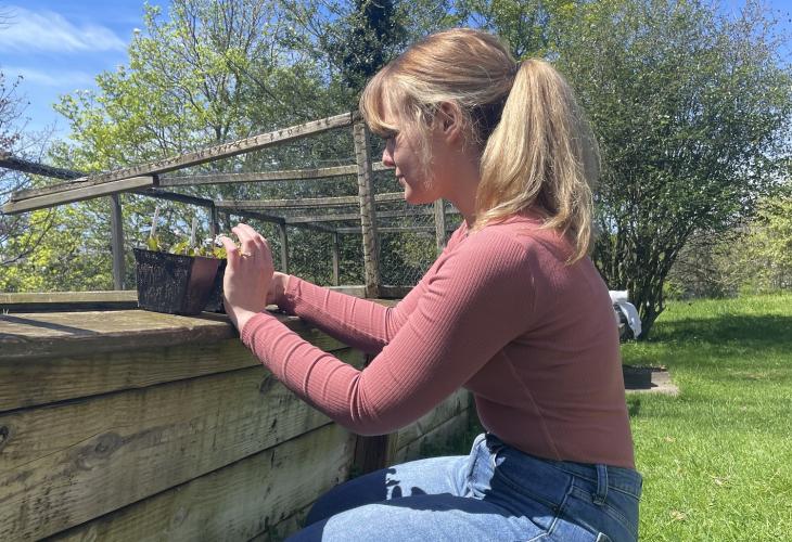 Emily Barbee is shown outside doing research