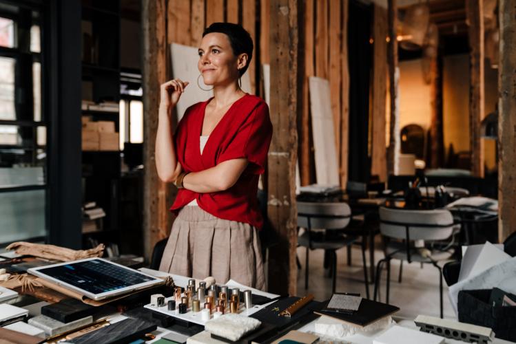 An interior designer in an office looking outward