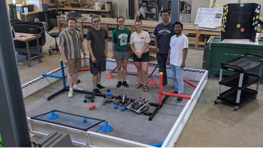 A group of people pose for a picture standing in a lab