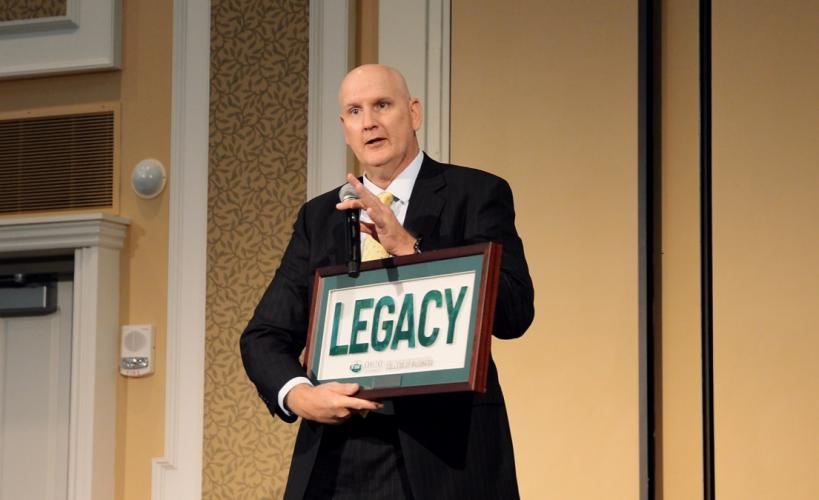 Greg Moran holds a sign that says "Legacy" during an OHIO event