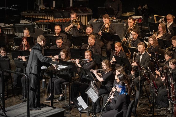 The Ohio University Wind Symphony is shown performing