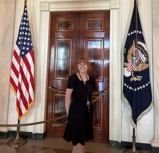 Ava Hamilton stands next to flags at the Appalachian Regional Commission office in Washington, D.C.