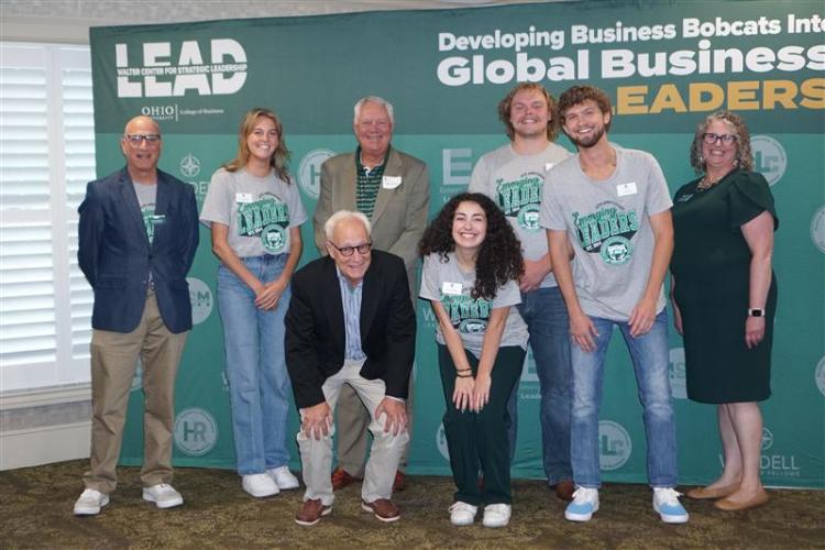 OHIO students, faculty, staff and alumni pose for a photo at the anniversary event