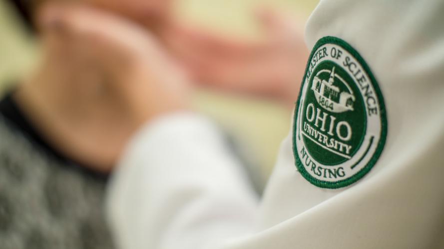 Closeup of a the badge of an Ohio University nursing student.