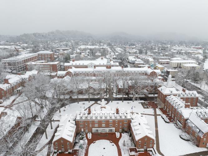 The East Green is shown covered in snow, with the city of Athens in the background in this aerial image