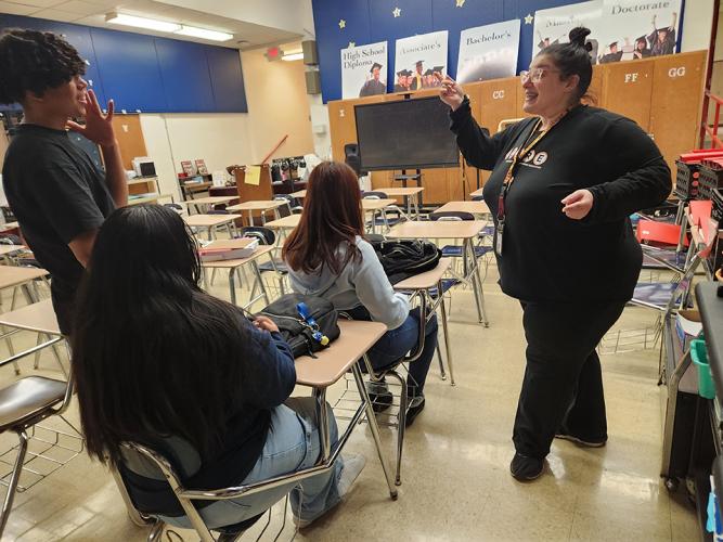 Ohio University Arts in Health graduate student working with high school students singing 