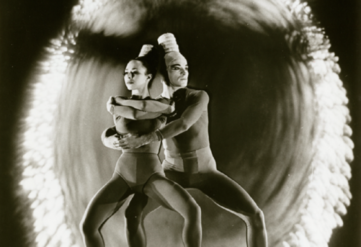 Two individuals are shown dancing in this black and white image