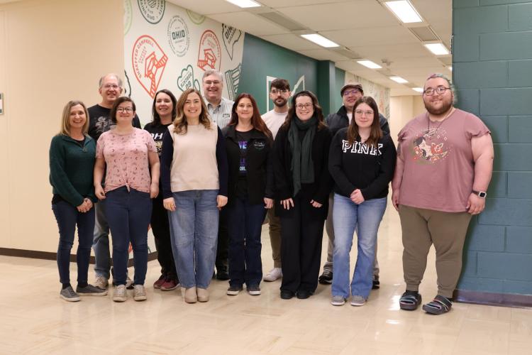 Group of people standing and smiling