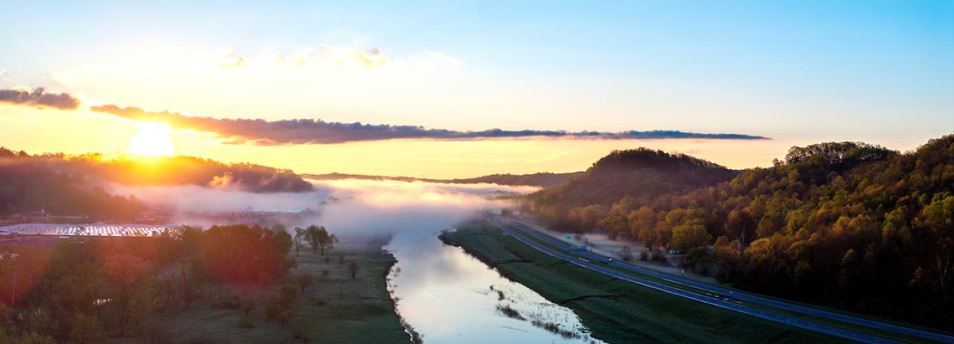 An aerial image of the Hocking River and the highway and surrounding countryside with fog in the air on a spring morning