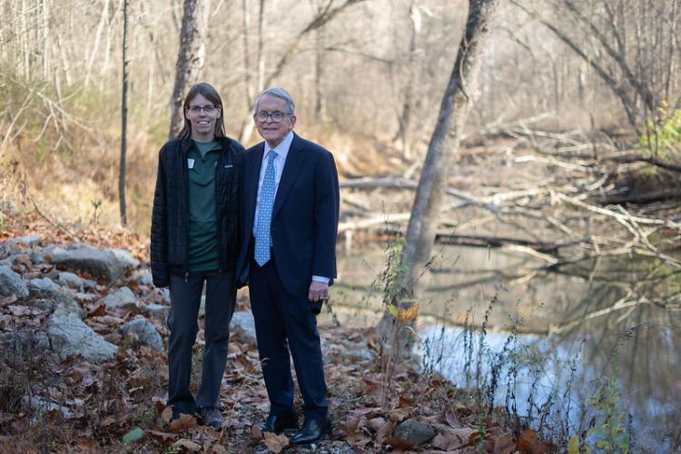 OHIO Governor Mike DeWine and a member of the Raccoon Creek Partnership stand beside Raccoon Creek