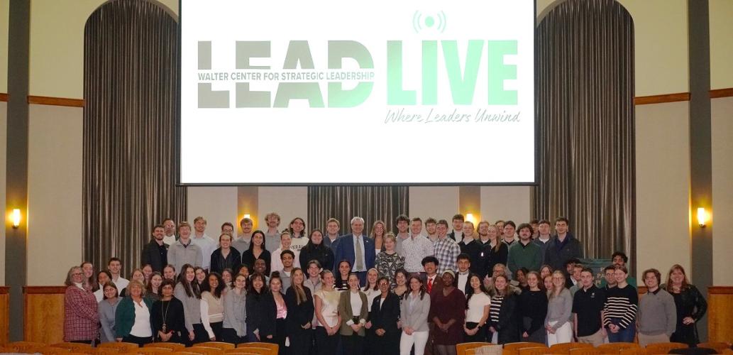 OHIO students, faculty and staff stand in front of the LEAD Live graphic in the Walter Rotunda