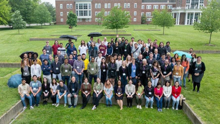 Participants in the Frontiers in Nuclear Astrophysics Meeting stand together for a photo outside on the Ohio University campus