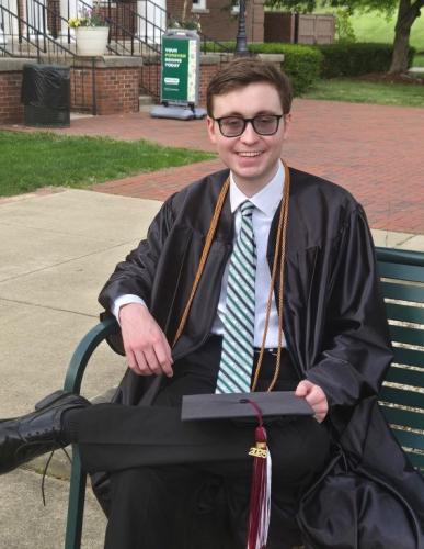 Seth Southers sits in front of Bennett Hall