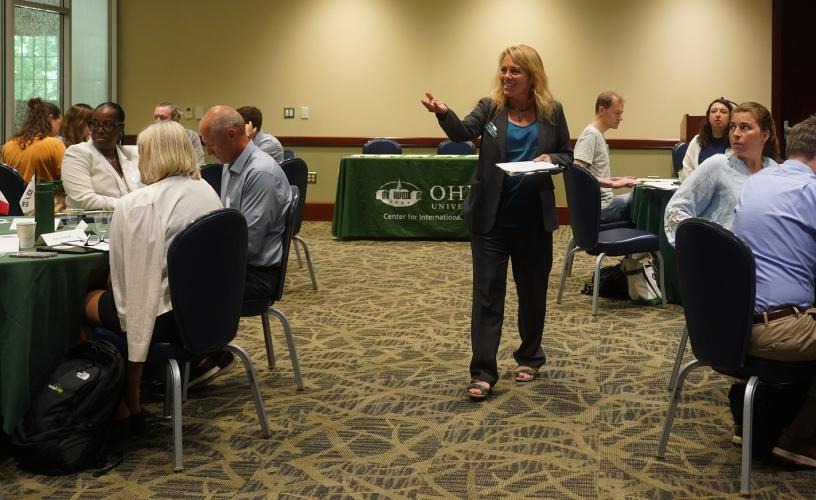 Dr. Haley Duschinski walks among the crowd and leads a presentation