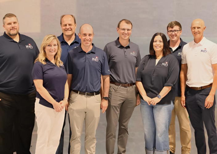 Eight representatives from Mars Electric stand together for a photo