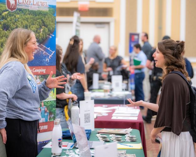 Megan Albers talks to an OHIO student at the Career Fair in the Baker University Center Ballroom
