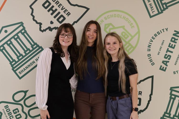Three females standing next to each other, smiling