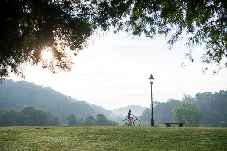 A student rides a bike on the Hockhocking Adena Bikeway.