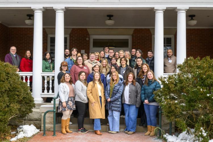 OHIO students, faculty, staff and alumni stand together for a group photo outside on the day of the luncheon