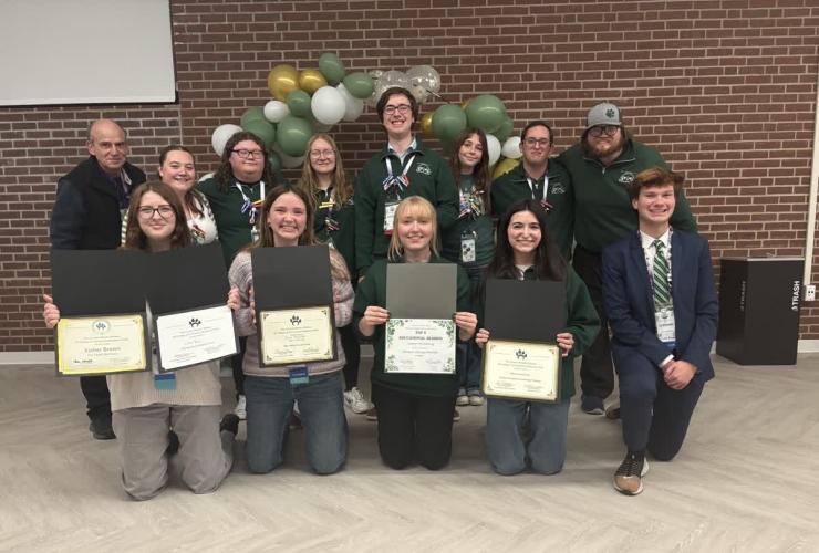 OHIO students and staff from Housing and Residence Life pose for a group photo while holding their awards