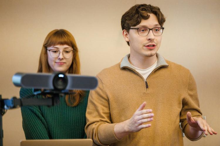 Spencer Johnson gives a presentation while another OHIO student looks on from behind him