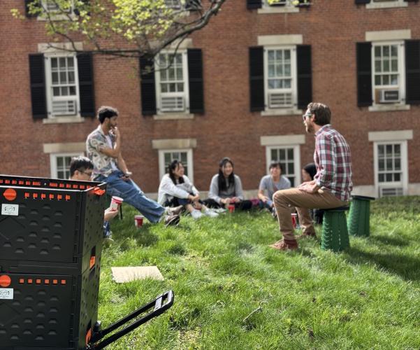 An  OHIO faculty member leads a class  outside, while the Outdoor Class Kit container is nearby