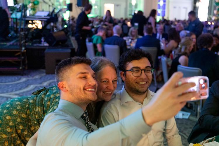 Students and alumni take a selfie at the HCOM gala