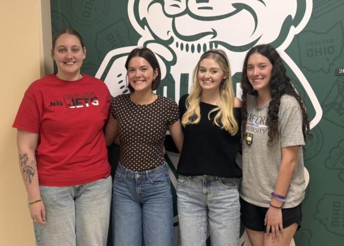 4 Education students standing together smiling