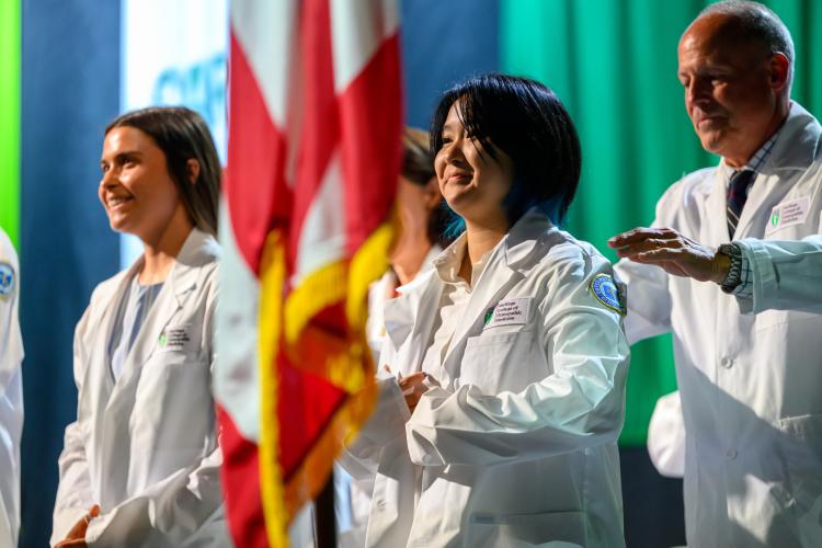 HCOM students receive their white coats
