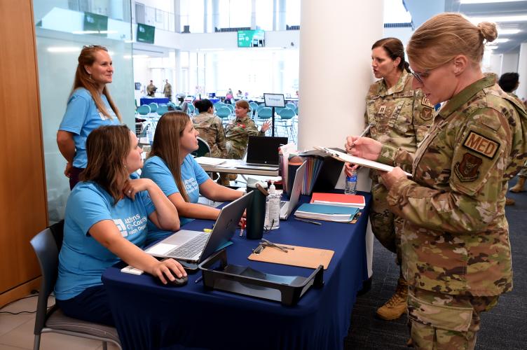 National Guard members and staff from the county health department prepare to assist patients