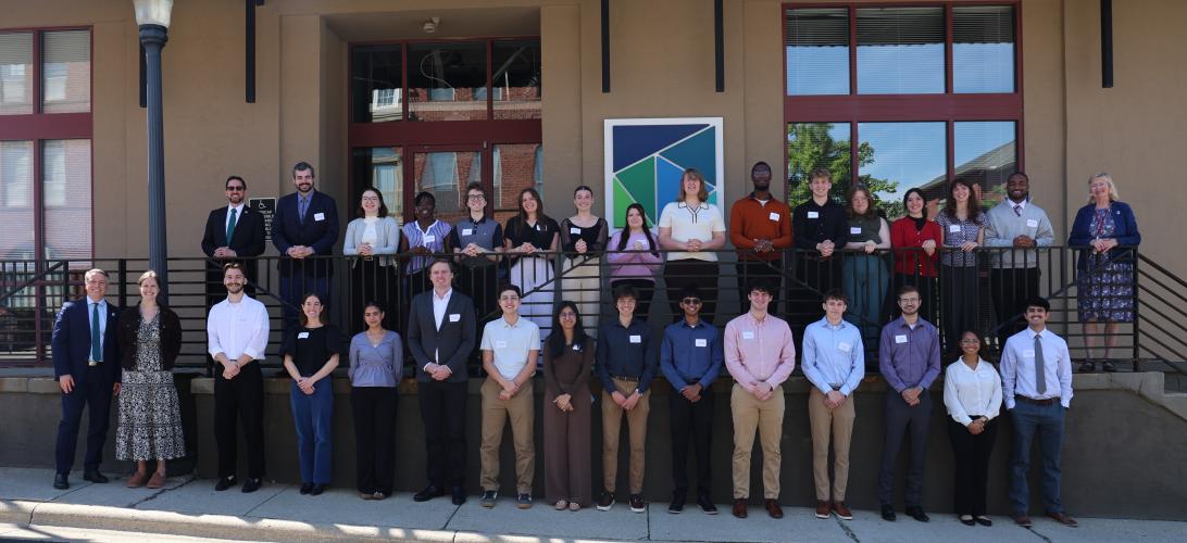 The 2026 MORPC interns stand together for a photo while they are outside in front of a building