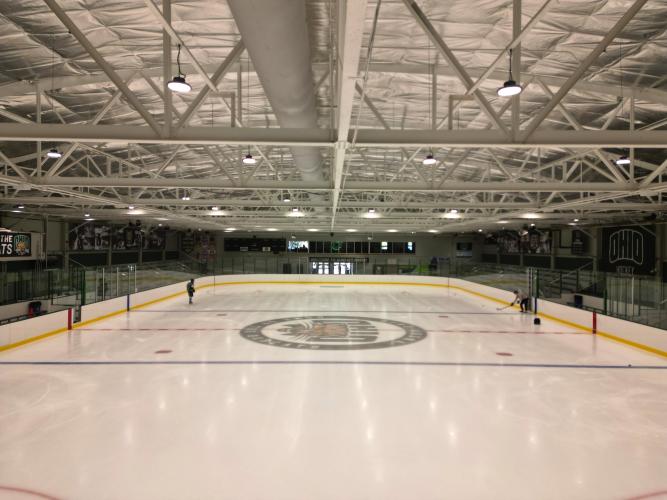 The new ice is shown inside of Bird Arena. Two people are shown skating on the ice in the background.