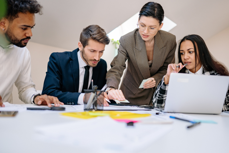 four people discussing a project at a table