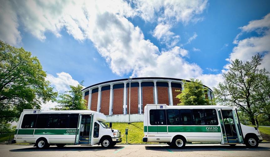 Two OHIO shuttles are parked in front of the Convocation Center