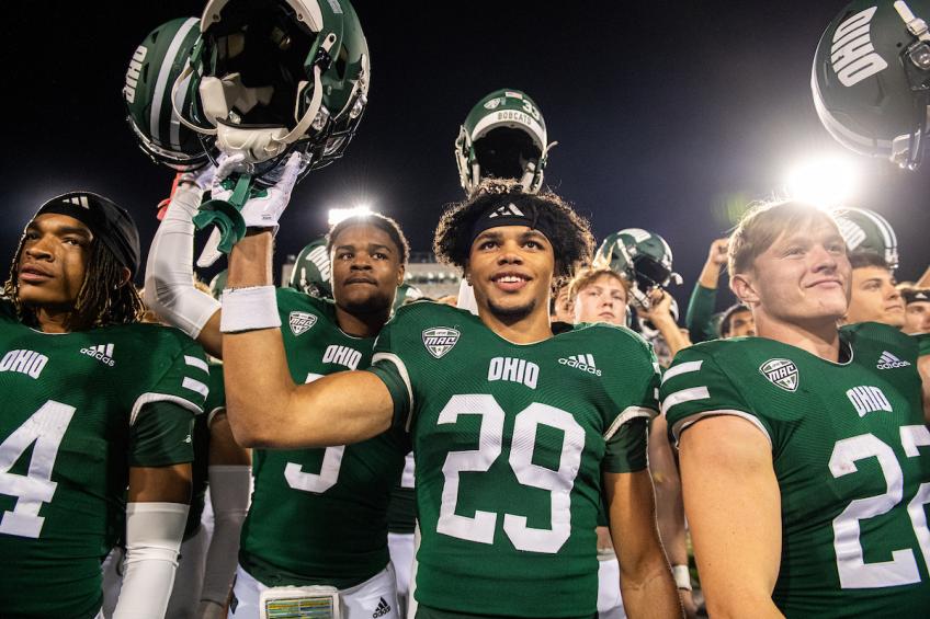 OHIO football players celebrate after a victory in Peden Stadium.