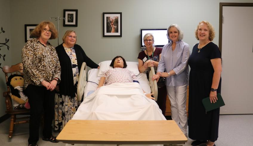 Hannah Nissen is shown with OHIO Zanesville representatives in a medical training space