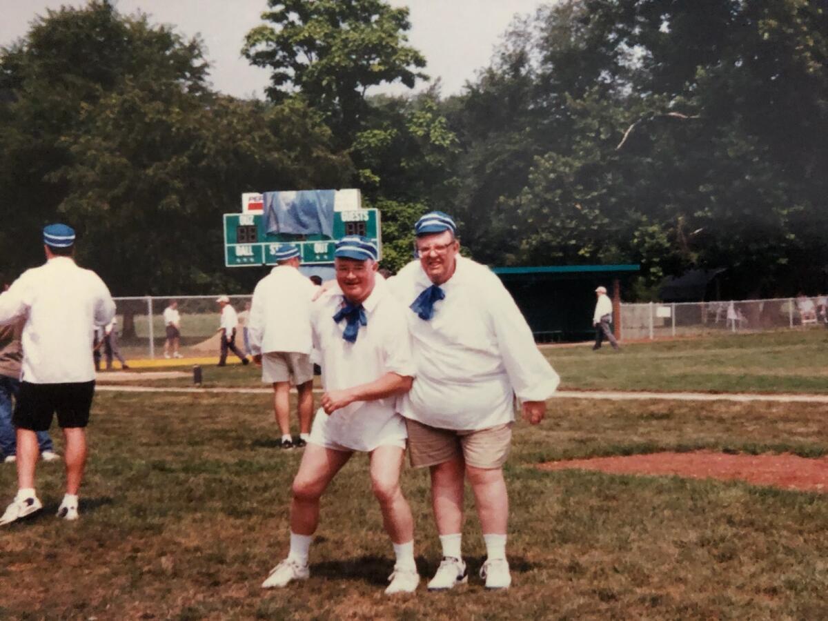 George Ware (left), an English professor, with Mike Kline at Ohio University Zanesville, between innings during an old-time baseball game.