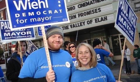 Rob Dorans holding a campaign sign for Paul Wiehl