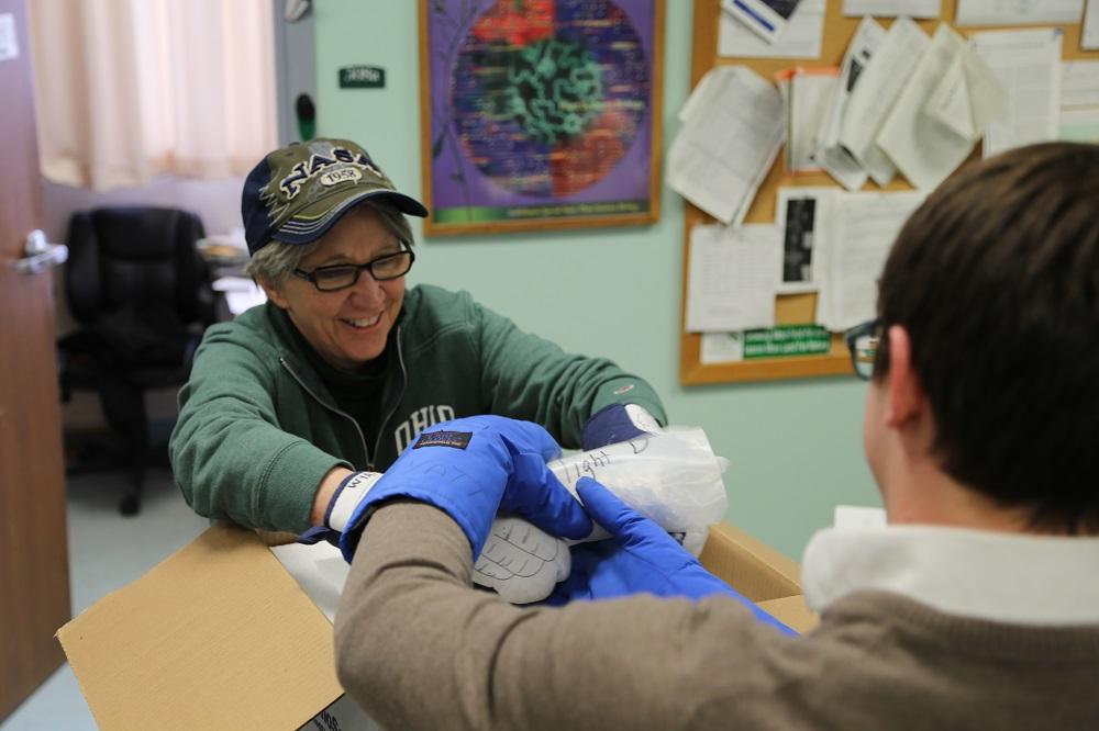 Sarah Wyatt and Colin Kruse unpack the frozen samples that flew on the International Space Station.