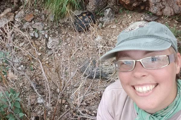 Julia Joos is shown in the foreground, and a tortoise is in the background