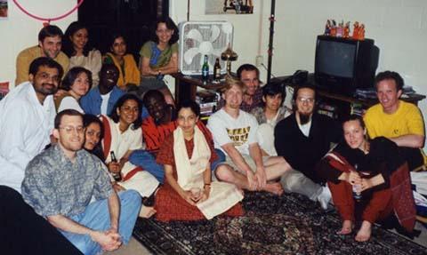 Andreas Weichselbaum and friends sit on the floor of a student's house