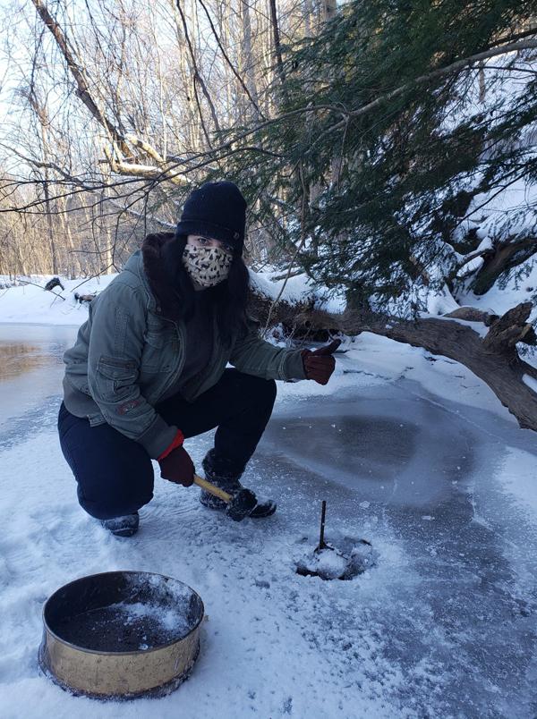 Ashley Grace is shown after chipping away at the ice to college a leaf bag