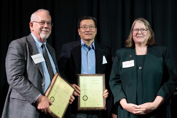 Steve Bergmeier and Xiaozhuo Chen are shown with Provost Elizabeth Sayrs 