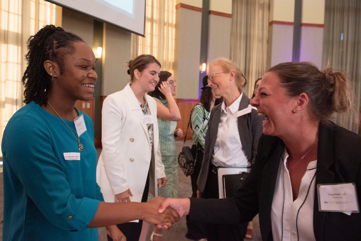 Women shaking hands and laughing