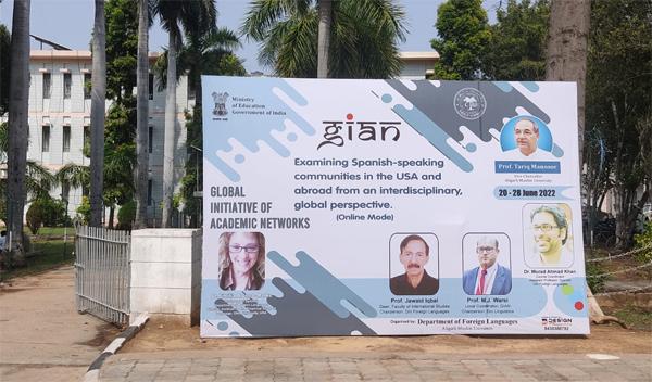 A poster advertises the seminar on the campus of Aligarh Muslim University.