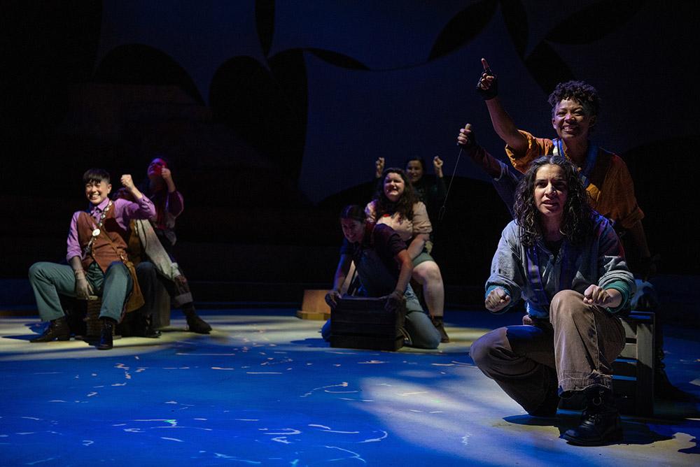 Group of actors sitting on stage props