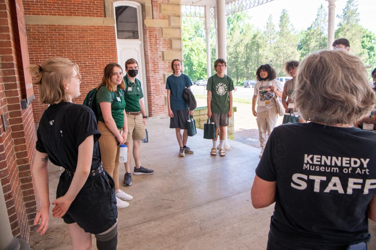 A group of students in the Sibling Orientation gather outside