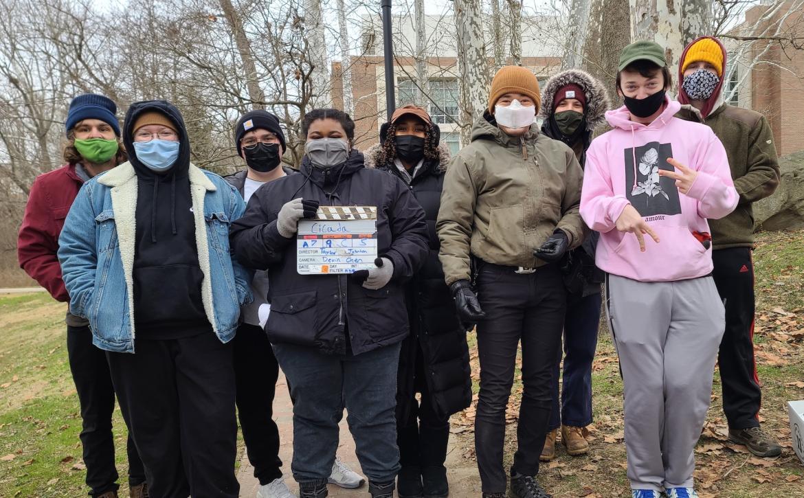 Taylor with their crew, posing for a picture